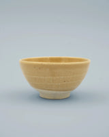 Yellow rice bowl with rustic base
