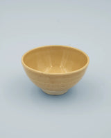 Yellow rice bowl with rustic base