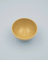 Yellow rice bowl with rustic base