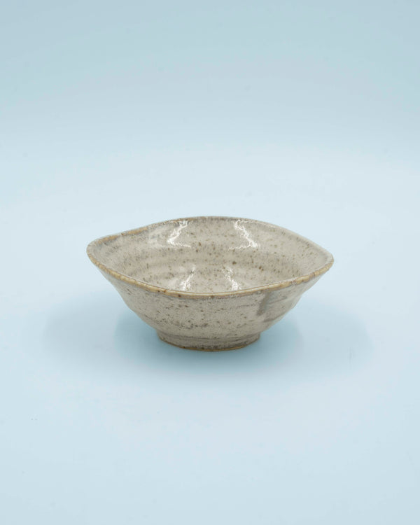 Asymmetric sand colored bowl