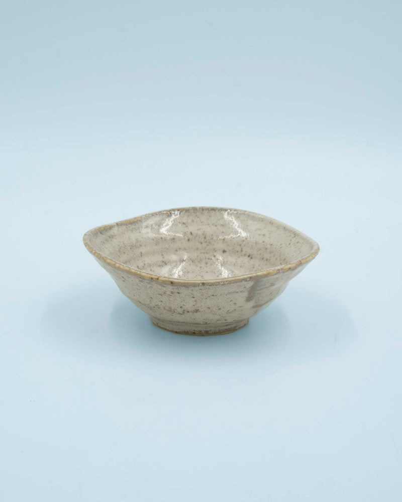 Asymmetric sand colored bowl