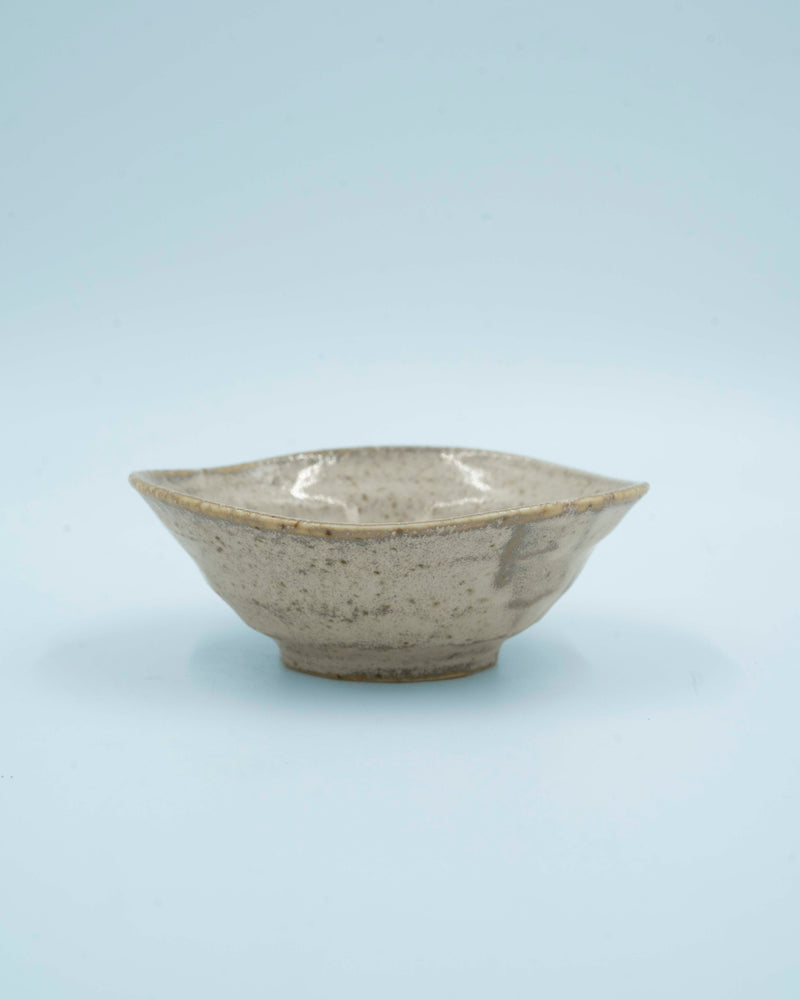 Asymmetric sand colored bowl