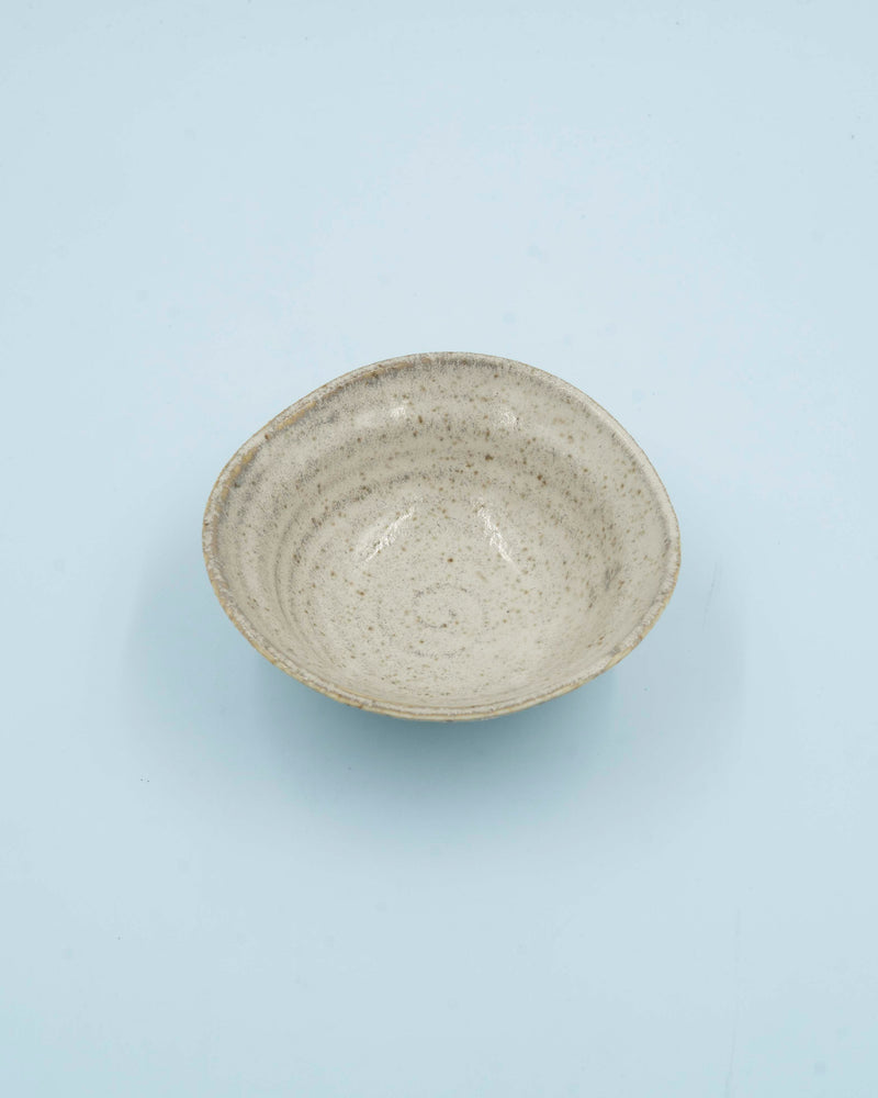 Asymmetric sand colored bowl