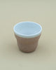 Brown/white cup with rough exterior 