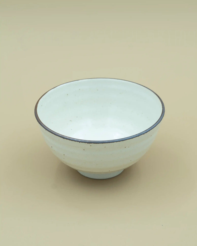 White bowl with dark rim 