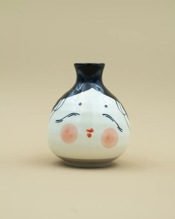 Sake jug with otafuku face