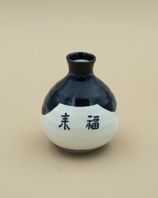 Sake jug with otafuku face